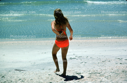 Woman walks into the water, beach, tanning, sun worshipper, bikini