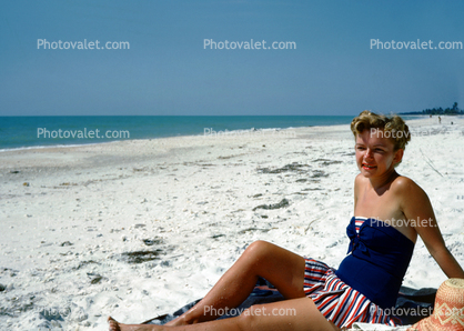 Woman Sitting in the Sun, beach, skirt, 1950s