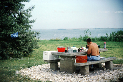 Shirtless Man, Coolers, Table, Lake