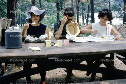 Women, hats, picnic table, 1960s