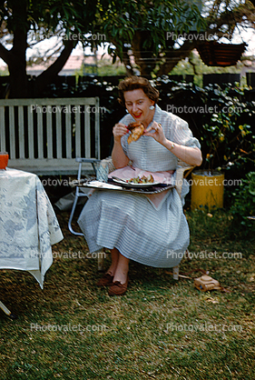 Woman Eating a Drumstick, meat, backyard picnic, 1950s