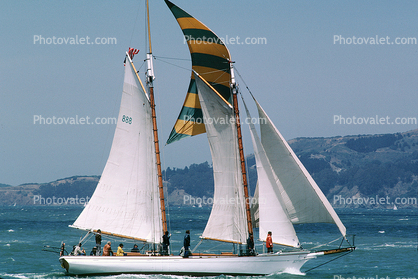 Many sails billowing on a sailboat, wind, windy