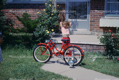 Girl with her new Bike, Training Wheels, 1950s