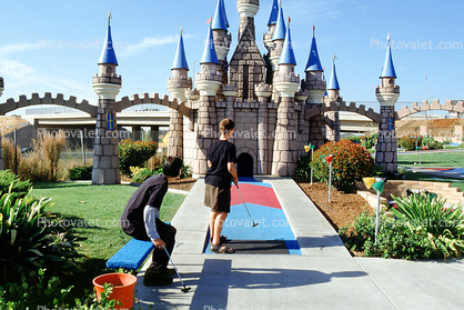Boys playing Miniature Gold, putting, castle
