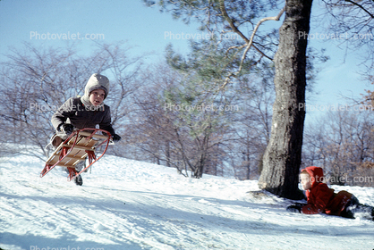 Boy launches into the air on a Sled, Snow, Winter, 1950s