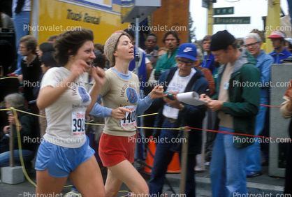 Woman runner, World Runners, crowds, spectators, Oakland Half Marathon finish line