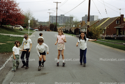 Kids Roller Skating on the Street, Girls, Boys, fun, suburbs, 1960s