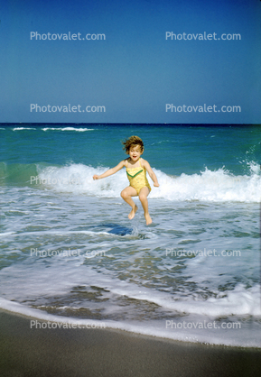 Girl Jumps in the water, ocean, wave, sand, 1950s