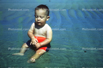 Boy sits in water