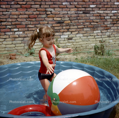 Little Girl Plays with a Big Ball, Backyard swimming pool, water, 1950s