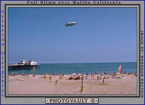 Malibu Pier, Volleyball, sun worshipers, crowds, people, shoreline, Airship Industries Skyship 500, G-SKSB Blimp, Pacific Ocean