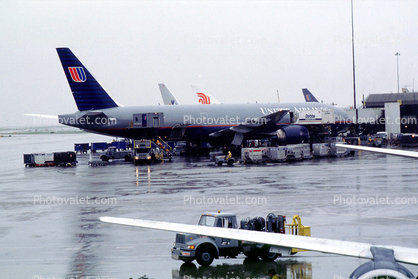 N228UA, United Airlines UAL, Boeing 777-222ER, (SFO), rain, inclement weather, wet