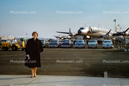 Woman Standing at the Airport, cars, N6227C, L-1049, EAL, 1955, 1950s