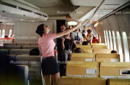 boarding passengers, woman, storage bin, 1971, 1970s