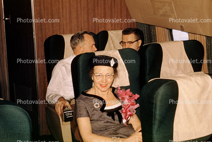 Passengers on a flight, Seats, Seating, Woman, Corsage, hat, smiles, 1950s