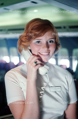 Stewardess on the intercom, Flight Attendant, Cabin Crew, Hostess, October 1975, 1970s