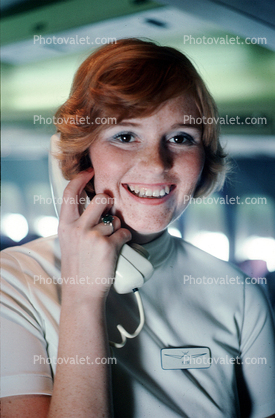 Stewardess on the intercom, Smiles, Teeth, hand, Phone, Flight Attendant, Cabin Crew, 1975, October 1975 1970s