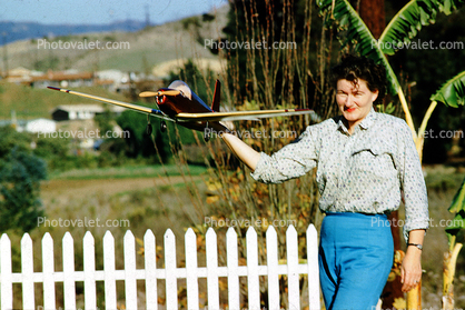 Woman, Plane, White Picket Fence, 1950s