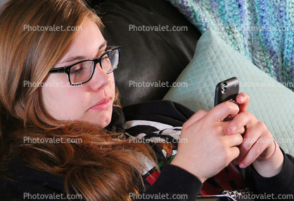 Teen Girl playing with her hand held device, I phone, Iphone, I-phone, cell phone, hand held device, hand, fingers, monitor, cloud computing, Iphone-4s