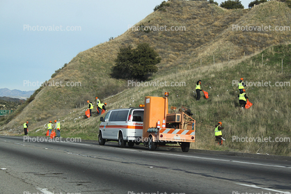 Cleaning up trash by the Highway, trailer, port-o-potty, hillside