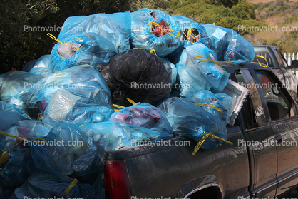 Pickup truck filled with trash bags