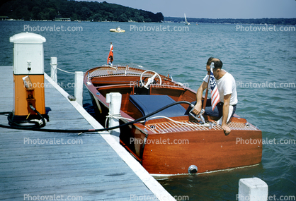 Man Fueling Old Powerboat, Dock, Fuel Pump, Hose, 1950s