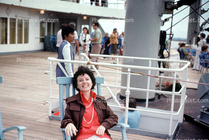 Woman lounging on ship deck, Passengers, July 1973, 1970s