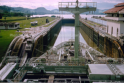 a ship about to go through a partially open lock in the Panama Canal, Mules, Cog, Railway, Rail, Gatun Locks, 1966, 1960s