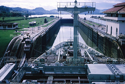 a ship about to go through a partially open lock in the Panama Canal, Mules, Cog, Railway, Rail, Gatun Locks, 1966, 1960s