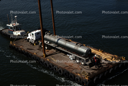 Tugboat Pushing a Raft, Semi Tanker Truck