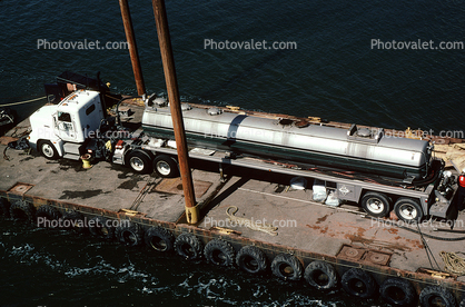 Tugboat Pushing a Raft, Semi Tanker Truck