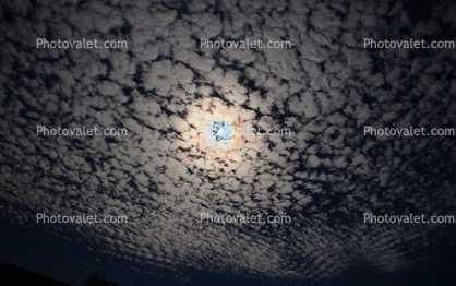 Moon with alto cumulus clouds