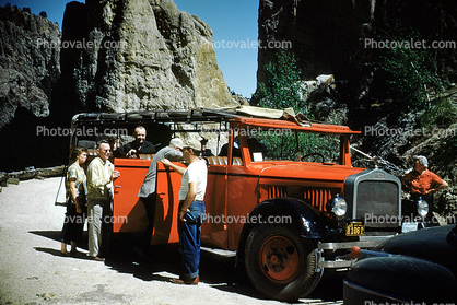 red touring bus, 1950s
