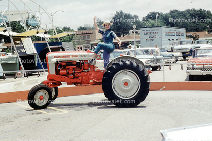 Ford 981 Select Speed, Ford Motor Company Road Show, woman posing on a tractor, December 1959, 1950s