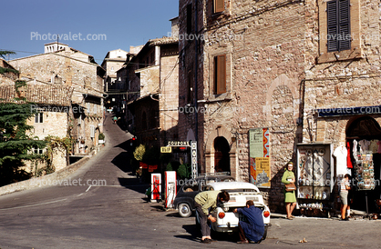 Street scene, buildings, car, Assisi Italy, Fiat minicar, mini-car, AGIP Gas Station, October 1969, 1960s
