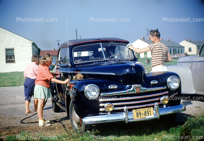 Family Washing the car, Ford Sedan, cabriolet, convertible, chrome grill, headlamps, girl, man, woman, 1950s