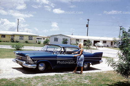1958 Plymouth Fury, tail fins, woman opens door, suburbia, 1950s