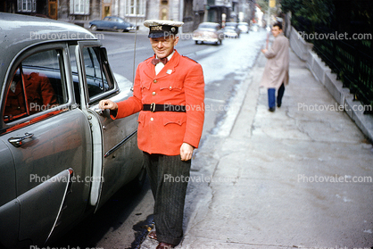Doorman, sidewalk, valet, man, smiles, belt, jacket, hat, Car, Automobile, Vehicle, 1940s