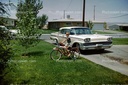 1959 Ford Mercury Monterey, Boy with his Bicycle, suburbia, driveway, 1950s