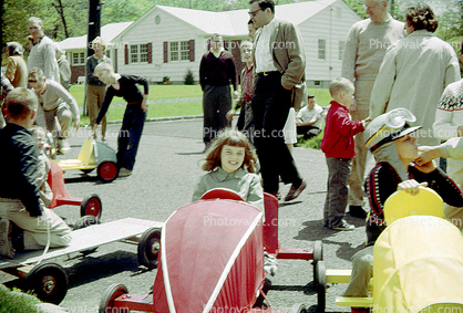 Smiling Girl in her Downhill Racer, Soap Box Derby, suburbia, 1950s