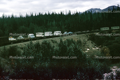 Caravan of RV's, on a train, near Skagway Alaska, August 1969