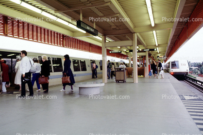 Passengers boarding BART, train platform, people, morning, station, commuters