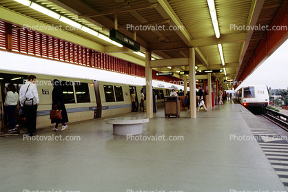 Passengers boarding BART, train platform, people, morning
