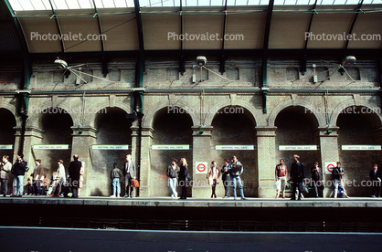 London Tube outdoors, station, platform, waiting passengers, building, arches
