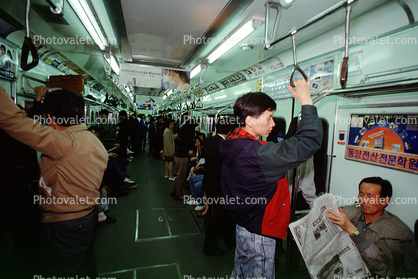 Commuters, men, railcar interior, Seoul