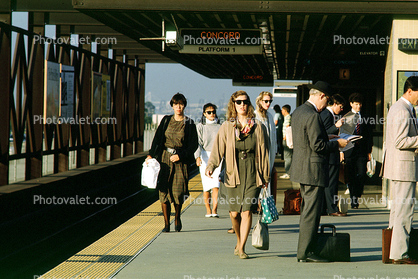 Passengers waiting for BART, station platform, commuters