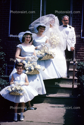 Bride and bridesmaids, flowers, 1960s