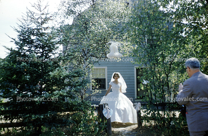 Bride under a paper Bell, backy7ard, home, house, 1950s