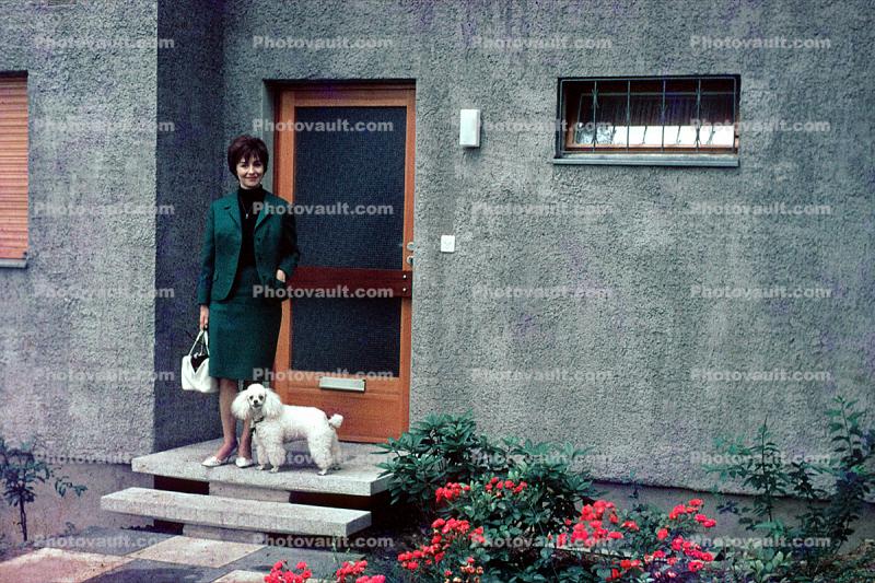 Woman and her Poodle, door, steps, flowers, wall, doorway, purse, dress suit, 1950s