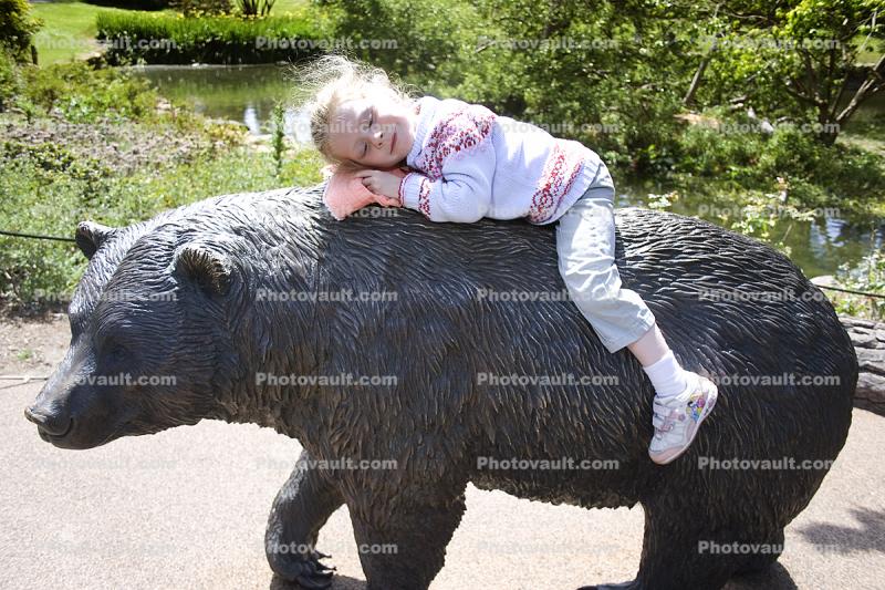 Girl on a bear statue